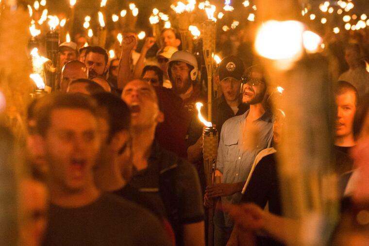 Neo-Nazis, white nationalists and white supremacists march through the University of Virginia the night before the Aug. 11 “Unite the Right” rally.