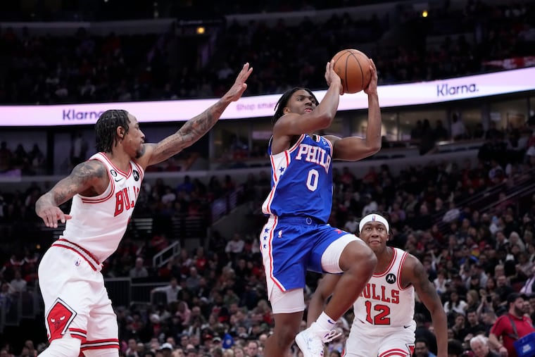 Philadelphia 76ers' Tyrese Maxey drives to the basket past Chicago Bulls' DeMar DeRozan, left, and Ayo Dosunmu.