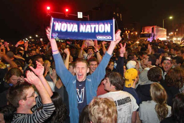 Hundreds of fans jam Lancaster Avenue in front of Villanova University after the Wildcats' victory. Holding his banner high among them is student John McCoey of Philadelphia.