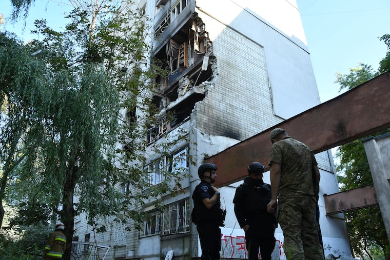 Rescuers work at a damaged apartment building following a Russian air attack in Lviv, Ukraine, Thursday, July 30, 2026.