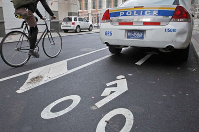 Squad cars routinely block the bike lane on 13th Street between Filbert and Arch. (Alejandro A. Alvarez / Staff Photographer)