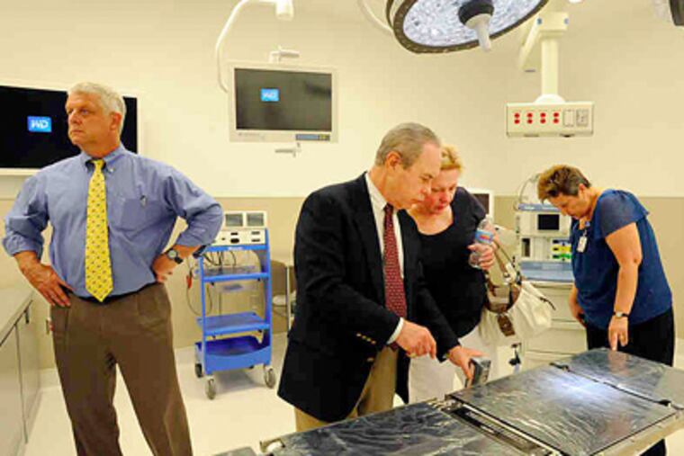 The mock operating room gets a look from (from left) Rick Fine, anesthesiology chairman; Bruce Menkowitz, an orthopedist who is chief of surgery; Patricia Clark, clinical manager for surgical services; and Ginger Kelly, clinical support specialist. (Sharon Gekoski-Kimmel / Staff Photographer)
