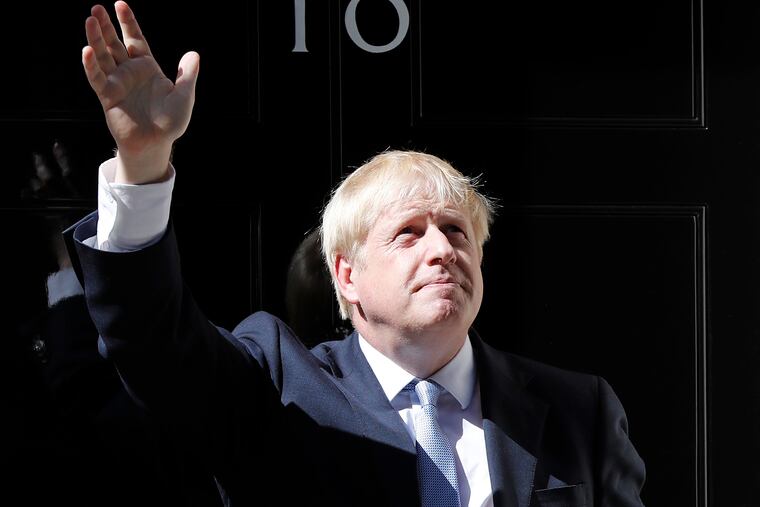 Britain's new Prime Minister Boris Johnson waves from the steps outside 10 Downing Street, London, Wednesday, July 24, 2019. Boris Johnson has replaced Theresa May as Prime Minister, following her resignation last month after Parliament repeatedly rejected the Brexit withdrawal agreement she struck with the European Union.