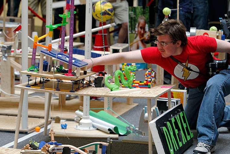 One of the students adjusts his project during final check at the nine-day, citywide Science Festival with an attempt to break the world record for the largest Rube Goldberg machine, with over 400 steps on April 25, 2014. ( AKIRA SUWA / Staff Photographer )