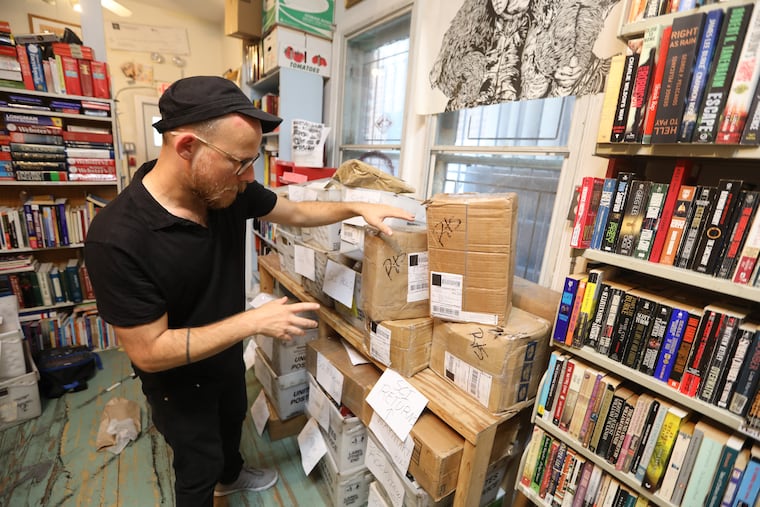 Keir Neuringer, a member of Philadelphia's Books Through Bars collective, sorts through packages of books that were supposed to go out to Pennsylvania prison inmates but were held back in September, 2018, after the Department of Corrections stopped allowing direct book donations.