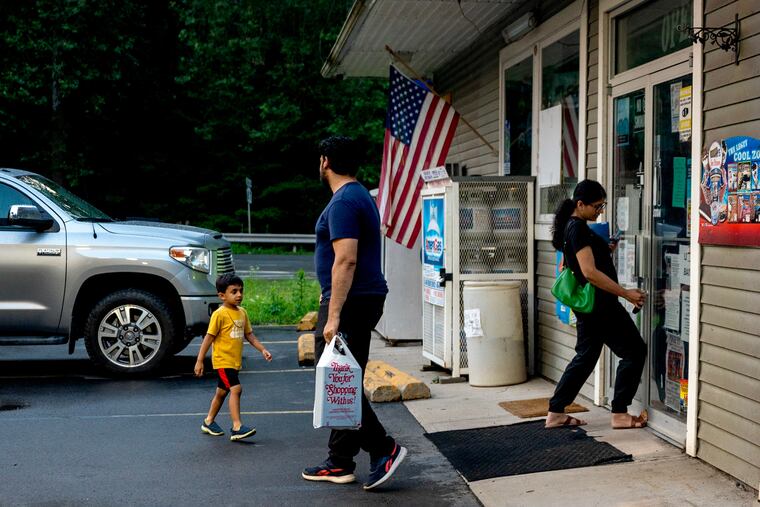 Shivani Patel (right) closes up the shop at the end of the day with husband Manny Patel and son Ekantik, 5, at their Sunoco gas station in Forksville June 23, 2024. Pennsylvania's rural population will plummet in coming decades and no county is older than Sullivan.  What does the future look like and who will take care of the aging population there?