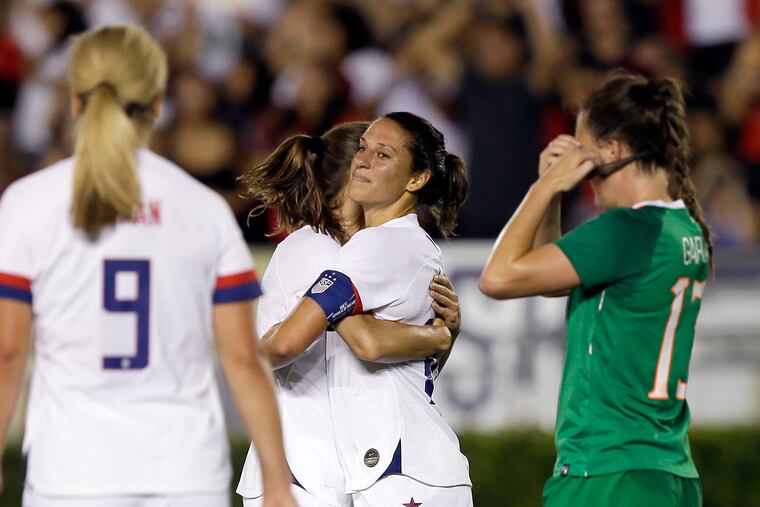 Carli Lloyd (center) embraces Tobin Heath after scoring in the U.S. women's soccer team's 3-0 win over Ireland. Heath also scored in the game.