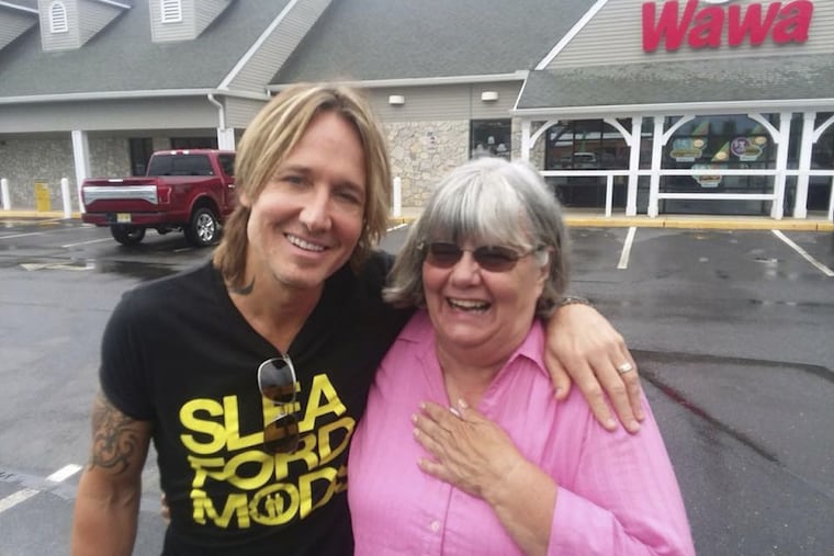 Country star Keith Urban poses with South Jersey substitute teacher Ruth Reed, who paid for Urban's snacks at a Jersey Wawa last week.