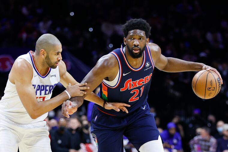 Sixers center Joel Embiid driving on Clippers forward Nicolas Batum on Jan. 21.