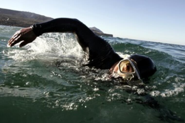 Valencia swims off Ensenada , top, using his muscular arms and shoulders to drag his legs through the water. Above, he displays his powerful upper body. His long-distance swimming feats once were celebrated. With a sponsor, he says, he could conquer new challenges.