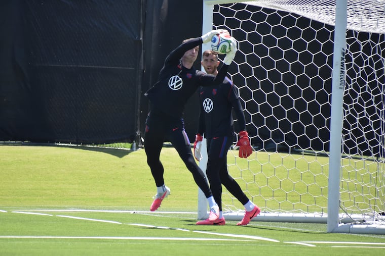 Matt Freese (left) jumps in front of Matt Turner to catch a ball in a drill at Tuesday's practice. Which Matt is in goal for the USMNT's group stage opener remains a mystery.