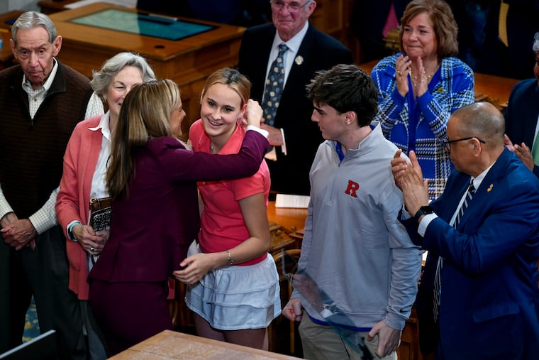 Gov. Mikie Sherrill greets her family following her budget address Tuesday, Mar. 10, 2026, in the Assembly Chamber at the New Jersey State House. From left are her parents, Dave and Pattie Sherrill; middle-school daughter Marit, and high school sophomore son Ike. Lt. Gov. Dale G. Caldwell is at right. Sherrill’s husband was traveling and their other two children are at the U.S. Naval Academy.
