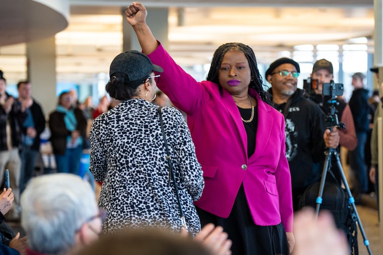 Civil rights attorney Nekima Levy Armstrong holds up her fist after speaking at an anti-ICE rally for Martin Luther King Jr. in St. Paul, Minn., on Monday, Jan. 19.