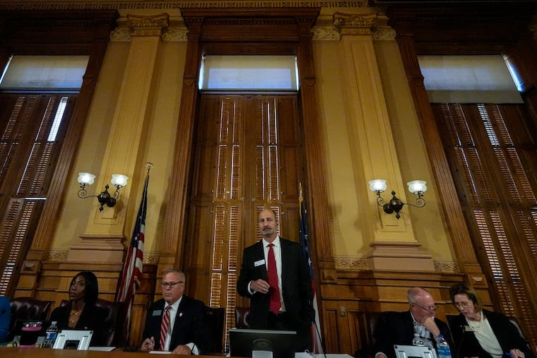 Georgia's State Election Board members discuss election rule changes at the state capitol on Friday.