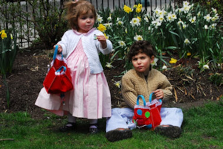 Sophia Murray , 2, and brother William, 4, of Philadelphia hunted for candy after church in Rittenhouse Square.