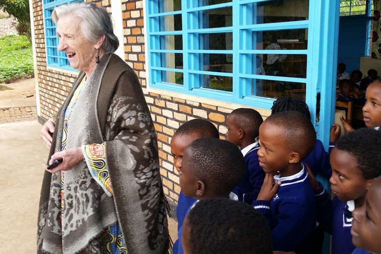 Arlene Brown is joined by some of the children who are housed and schooled at Urukundo Village, a home for children about an hour outside Kigali, Rwanda, created and funded through Hope Made Real.