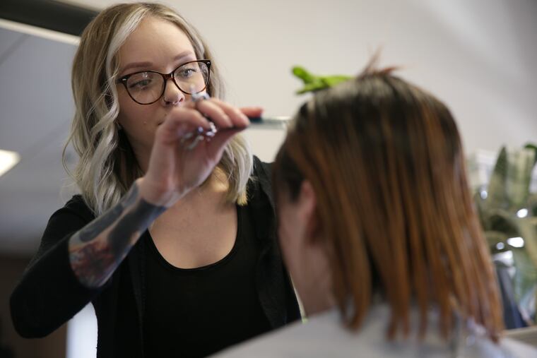 Allyson Lynch (left) cuts Gillian Schlesinger's hair at Tangled Hair Studios. Lynch is a breast cancer survivor who works as a hair stylist. She was out of work for nine months during treatment and lost a lot of clientele. Five years later, she's finally built it back up.