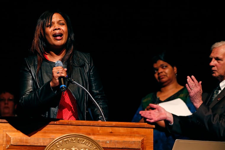 Leah Coleman, a worker in the state Department of Children and Families who was stabbed nearly two dozen times, speaks at a gathering of the Communications Workers of America in Trenton. RICH SCHULTZ / For The Inquirer