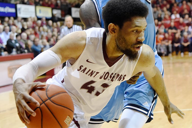 St. Joe's DeAndre' Bembry drives around Rhode Island's Jared Terrell.
