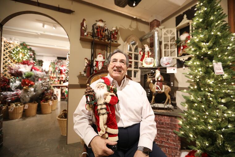 Owner Steve Cartozzi sits in Santa's chair at The Hardware Center in the Paoli Shopping Center, a family-owned shop where toys, tools and holiday decorations have been for sale for nearly 70 years.