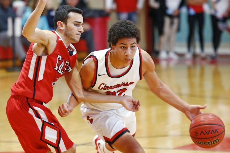 Craig Turner of Cinnaminson drives past Jared Ohnona of Cherry Hill East in the third quarter during the Coney Classic basketball tournament Saturday, Jan. 27, 2018, at Rancocas Valley. Cinnaminson went on to win, 56-49.