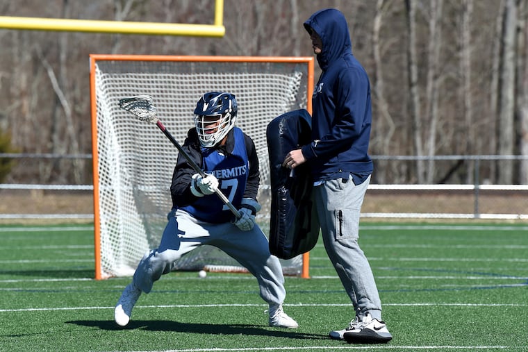 St. Augustine Prep defenseman Brandon Gibson practices with defensive coach Bryce Young.