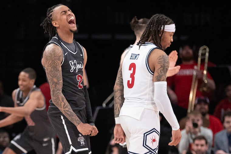 Erik Reynolds of St. Joseph's celebrates after the Hawks upset top-seeded Richmond during a quarterfinal game in the Atlantic 10 tourney.