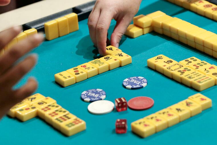 Members of the Philly Mah-Jawng Club teach others how to play Mahjong at ThirstyDice in the Spring Garden section of Phila., Pa. on July 17, 2019.
