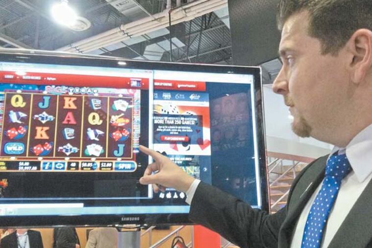 Bally Technologies, Inc.'s Mike McKiski, an interactive sales manager, shows off the company's i-Gaming platform at this week's Global Gaming Conference in Las Vegas. He is playing a slots game called Big Vegas on a website. The game is available on casino floors. (Photo by Suzette Parmley)