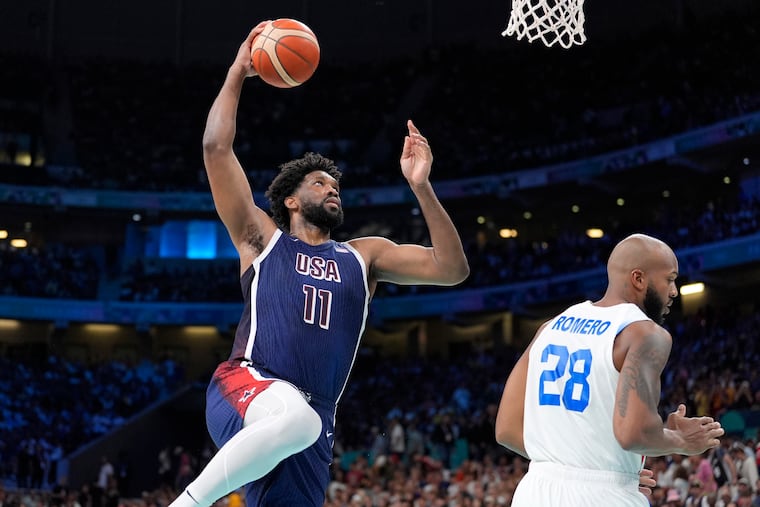 Joel Embiid of Team USA goes up for a dunk above Puerto Rico's Ismael Romero on Saturday.