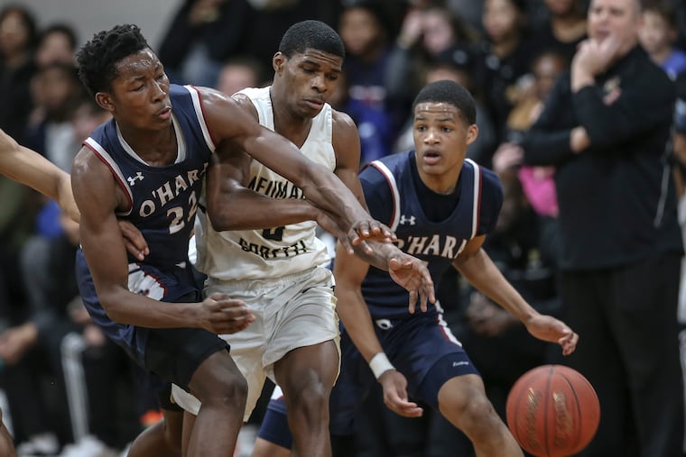 Neumann-Goretti's Hysier Miller collides with Cardinal O'Hara's Solo Bambara (22) and Jameel Burton (1) during the 4th quarter of the PCL quarterfinals in South Philadelphia, Friday, February 14, 2020. Neumann-Goretti beats Cardinal O'Hara 71-46