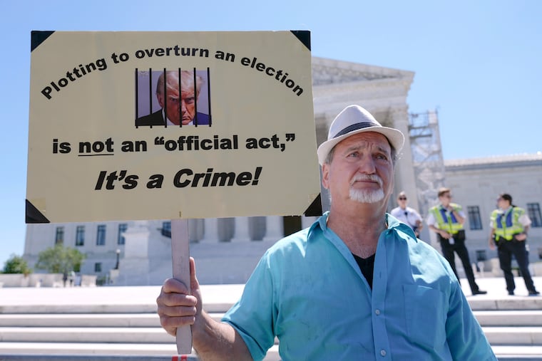 Gary Roush, of College Park, Md., protests outside the U.S. Supreme Court Building on Monday.