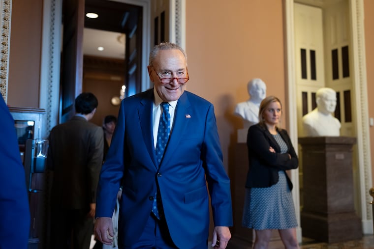 Senate Majority Leader Chuck Schumer, D-N.Y., grins as he emerges from the closed-door Senate Democratic Caucus leadership election on Thursday.