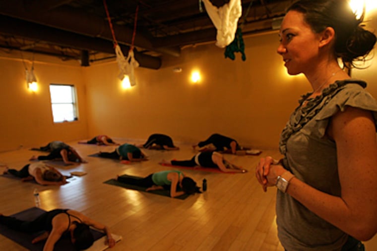 Yoga instructor Suzanne Awan teaches class at Yoga Shelter in Grosse Pointe, Mich. Yoga studios are seeing a rise in attendance. (William Archie/Detroit Free Press/MCT)
