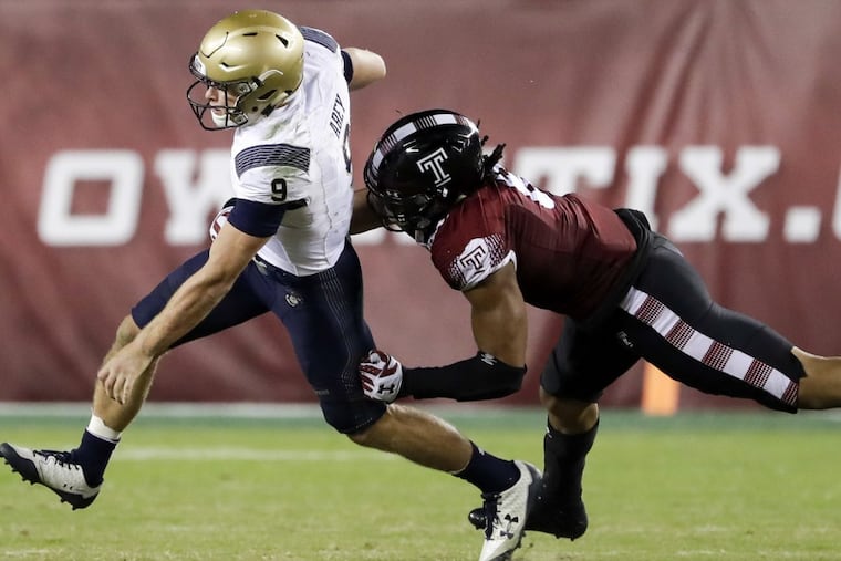 Temple defensive lineman Sharif Finch, right, runs down Navy quarterback Zach Abey during the fourth quarter on Thursday, Nov. 2, 2017, at Lincoln Financial Field in Philadelphia. (Yong Kim/Philadelphia Daily News/TNS)