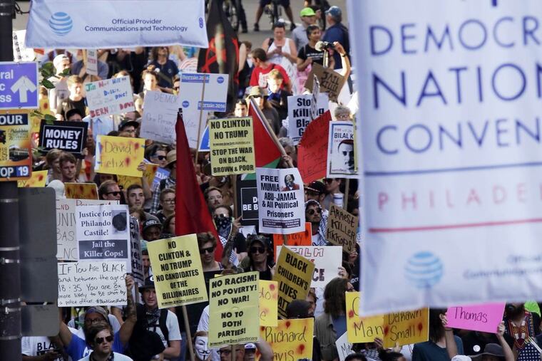 Demonstrators walk south on Broad Street between Walnut and Locust Streets on their way to the Wells Fargo Center and the DNC in Philadelphia on July 26, 2016.