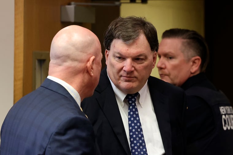 Rex Heuermann speaks with his lawyer Michael Brown during a court hearing where he was charged in the killing of Valerie Mack, inside Supreme Court Justice Timothy Mazzei's courtroom at Suffolk County Court in Riverhead, N.Y., on Tuesday. (James Carbone/Newsday via AP, Pool)