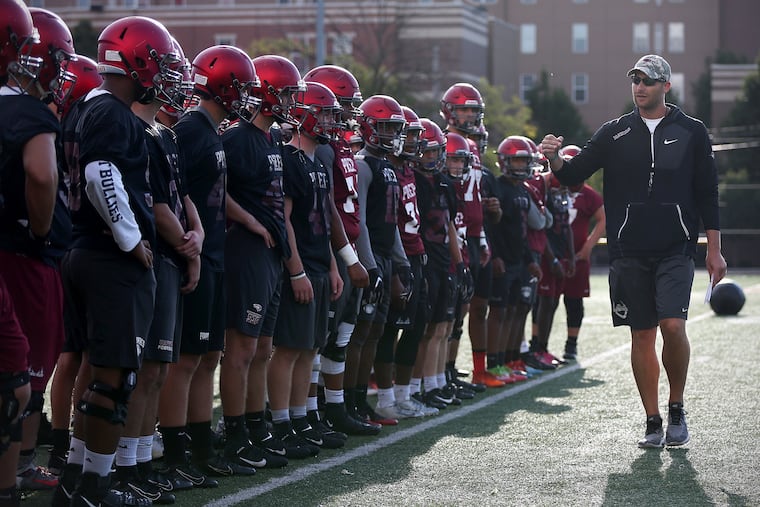 St. Joseph's Prep head coach Tim Roken (right) preaches trust and love to his players as well as football fundamentals.