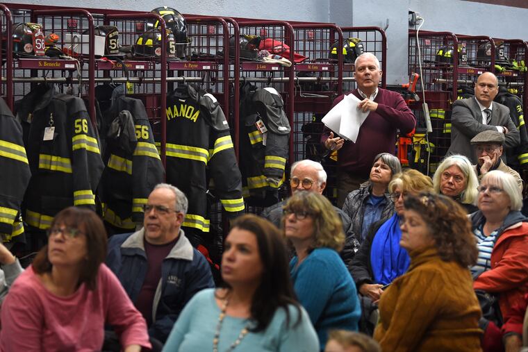 As Haverford Township prepares to return to court in its 10-year battle against the erection of billboards on two major roads, Solicitor James Byrne (left) and Commissioner Steve D'Emilio (right) address residents during a presentation at a town meeting at the Manoa Fire Company in Haverford on Tuesday.