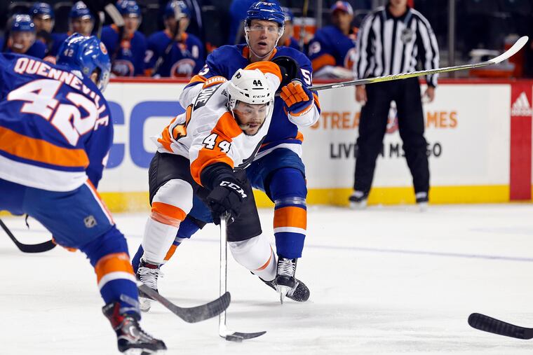 Phil Varone (center) battles for the puck during a Flyers preseason game in September. The 28-year-old is back on an NHL regular-season roster for the first time since the 2016-17 season.