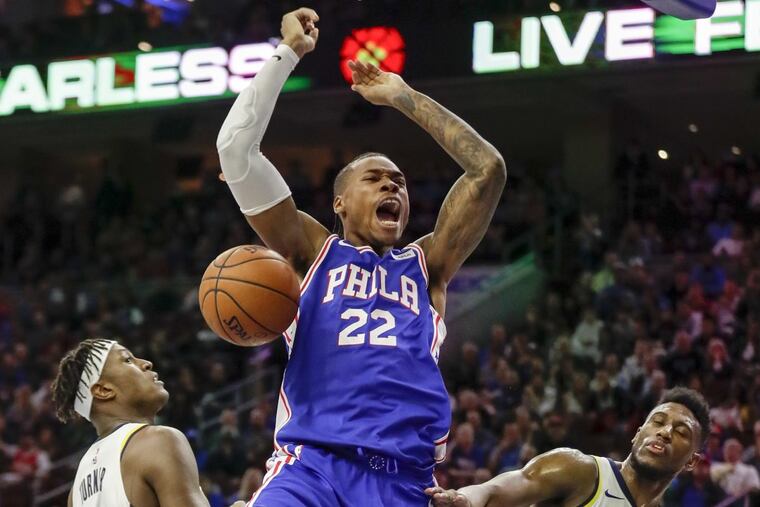 Sixers forward Richaun Holmes reacts after dunking the basketball off a missed Sixers shot past Indiana Pacers forward Thaddeus Young (right) and center Myles Turner during the third-quarter on Friday, November 3, 2017 in Philadelphia.