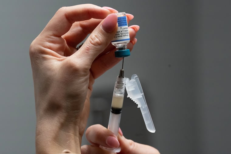 Lauren Ellenburg, a nurse, prepares a combination measles, mumps and rubella vaccine for a patient in Easley, S.C., in March. In Pennsylvania, health officials are recommending early vaccination for infants in some areas as measles cases increase.