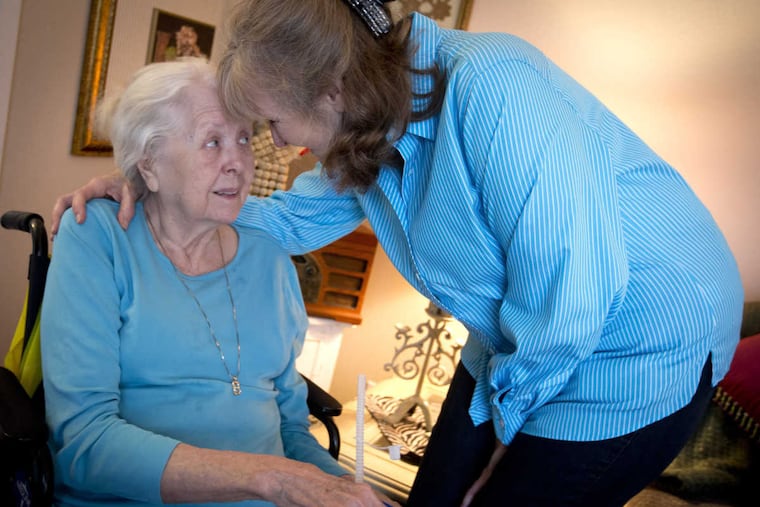 Barrie Page Hill, right, shares a moment with her mother Bobbie Wilburn, 79, in Arlington, Texas. Wilburn, who developed Alzheimer's disease, moved in with Hill.