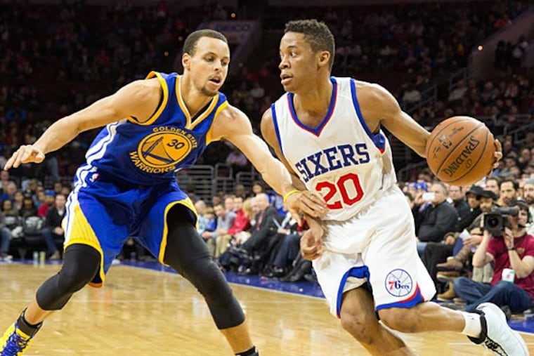 Philadelphia 76ers guard Tim Frazier (20) dribbles past Golden State Warriors guard Stephen Curry (30) during the second quarter at Wells Fargo Center. (Bill Streicher/USA Today)