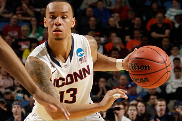 Connecticut guard Shabazz Napier (13) drives against Saint Joseph's forward DeAndre Bembry (43) during the first half of a second-round game in the NCAA college basketball tournament in Buffalo, N.Y., Thursday, March 20, 2014. (Bill Wippert/AP)