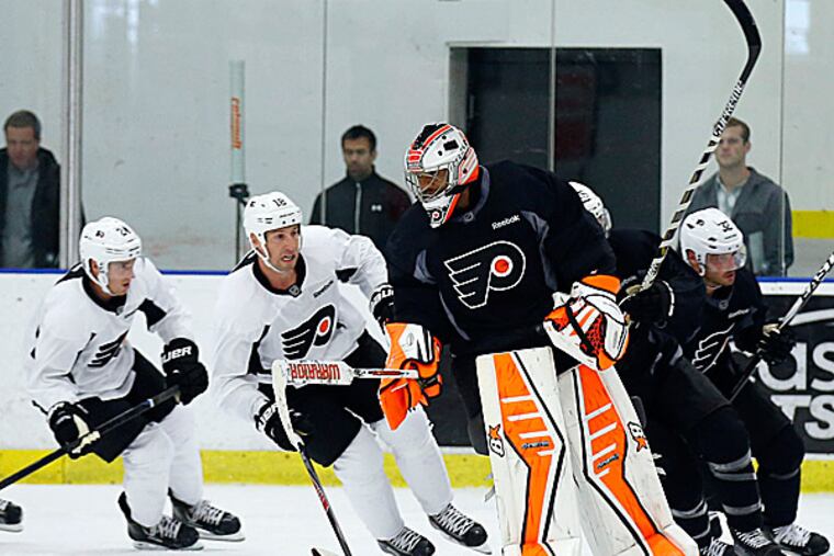 Flyers goalie Ray Emery and teammates warm up for practice. (Yong Kim/Staff Photographer)