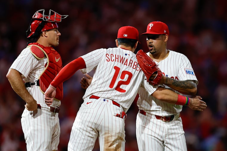 The Phillies' Kyle Schwarber, catcher J.T. Realmuto and pitcher Jhoan Duran celebrate a 2-0 victory over the Tigers on Sunday.