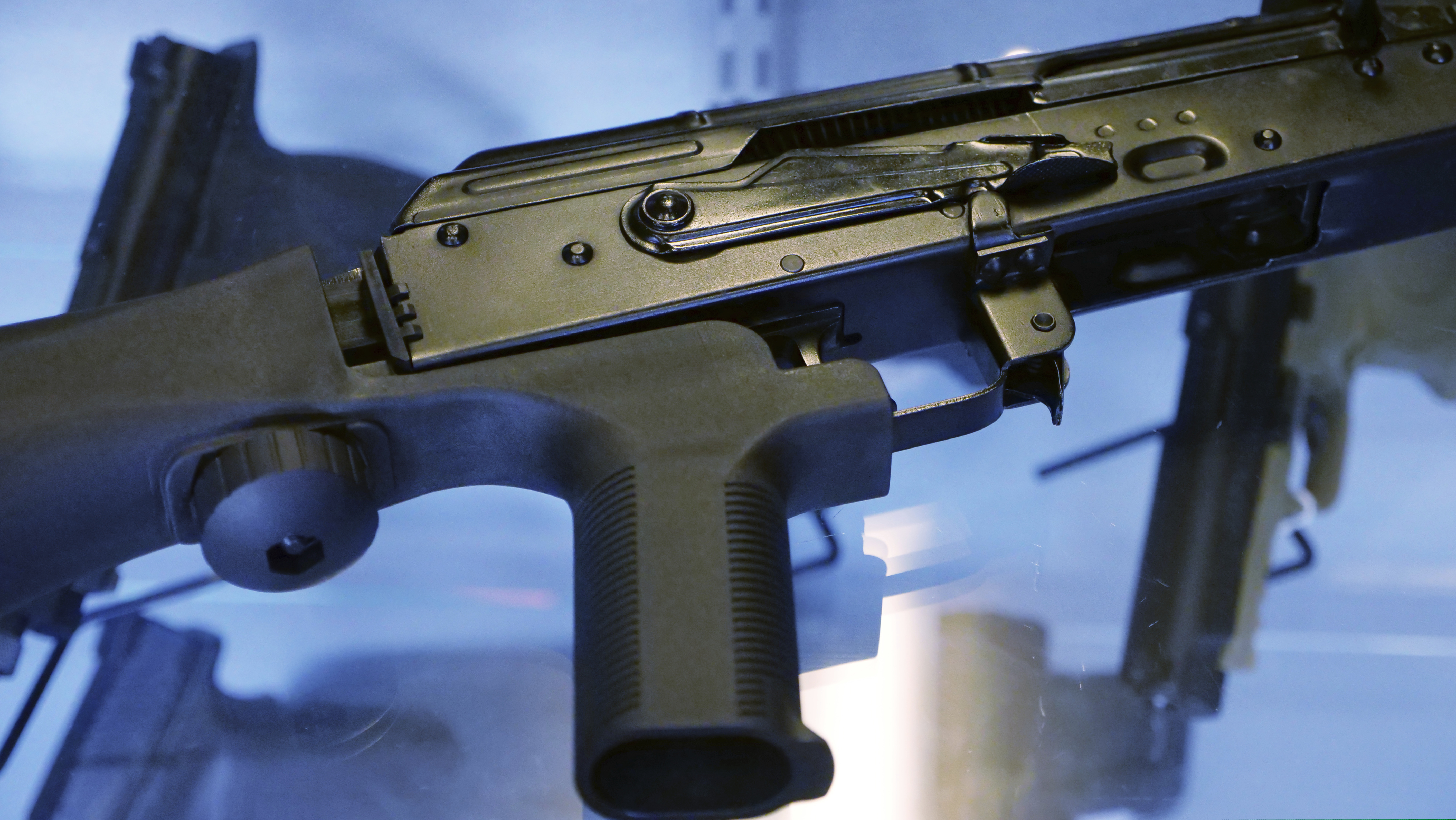 A device called a "bump stock" is attached to a semi-automatic rifle at the Gun Vault store and shooting range in South Jordan, Utah.