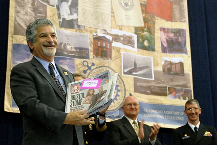 Alan Greenberger, Deputy Mayor for Economic Development, places Nov. 18, 2010 editions of the Philadelphia Inquirer and the Philadelphia Daily News newspapers into a time capsule during ceremonies commemorating the 100th anniversary of the Naval Surface Warfare Center Carderock Division - Ship Systems Engineering Station at the Navy Yard Nov. 18, 2010. ( Tom Gralish / Staff Photographer )