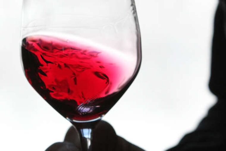 Galen Troxell shows off the beautiful color of Galen Glen's zweigelt.